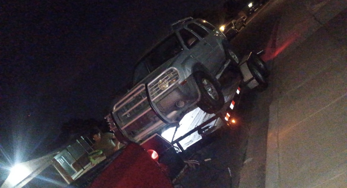 Vehicle being towed at night