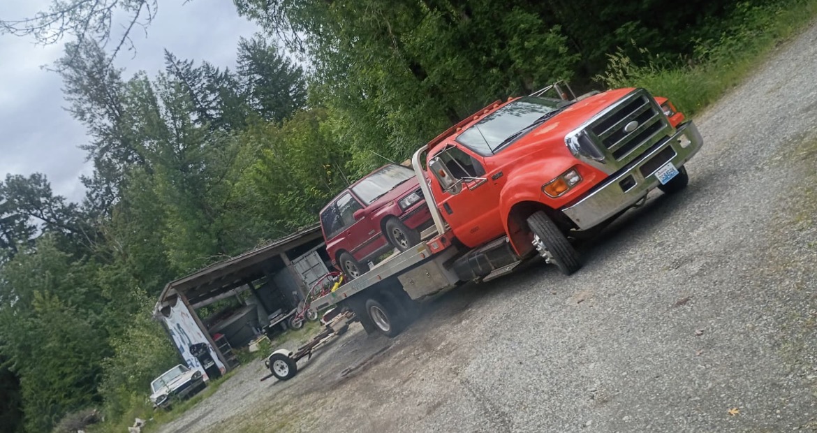 Red flatbed tow truck